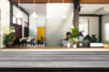 Selected focus empty brown wooden table and Coffee shop or restaurant blur background with bokeh image. for your photomontage or product display