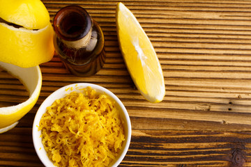Lemon essential oil on a wooden background