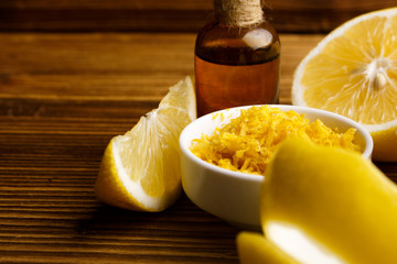 Lemon essential oil on a wooden background