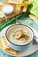 Diet menu. Puree soup mushrooms with croutons in a bowl on a kitchen wooden table. The concept of healthy eating.