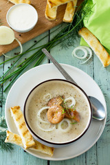 Puree soup mushrooms with croutons in a bowl on a kitchen wooden table. The concept of healthy eating. Diet menu. Copy space.