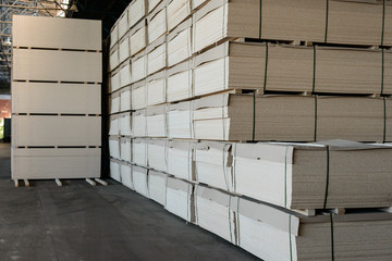 Stock of particle boards. Chipboards in the warehouse are ready for use. Woodworking industry