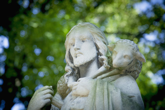Antique statue Jesus Christ Good Shepherd (fragment of ancient sculpture, close up)