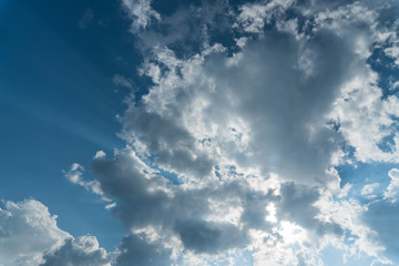 Clouds with sun rays on the blue sky