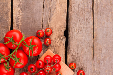 Whole uncooked fresh ripe tomatoes on wood. Copyspace. Wooden background.