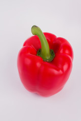 Paprika bell papper isolated on white background. Close up. One single shiny red pepper.