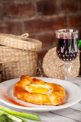 Traditional Georgian and Armenian cuisine. Khachapuri with suluguni cheese and egg yolk. background image. Copy space, selective focus