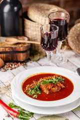 Traditional Georgian and Armenian cuisine. Tomato soup with rice Harcho of lamb, with walnut, garlic and cilantro. Copy space, selective focus