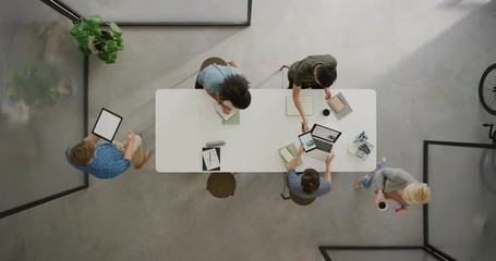 top view multi ethnic business people in boardroom meeting team leader sharing documents for corporate project colleagues planning successful strategy