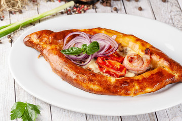 Traditional Georgian and Armenian cuisine. Khachapuri with suluguni cheese and egg yolk. background image. Copy space, selective focus