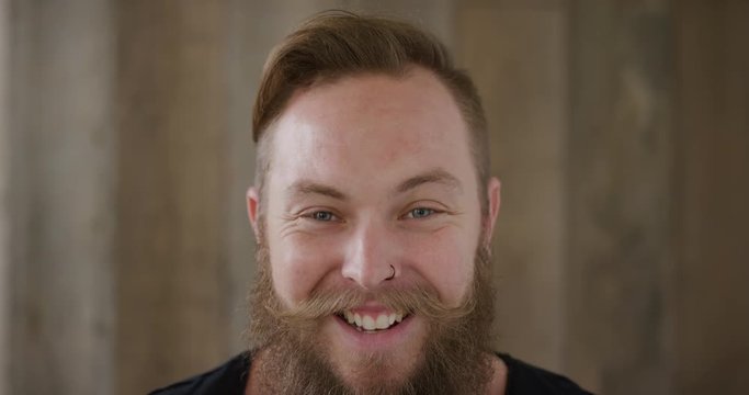 close up young hipster punk man with beard laughing cheerful enjoying successful lifestyle handsome independent male 