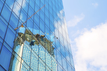 Reflection of the crane in the building window
