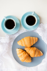 cup of coffee with croissant