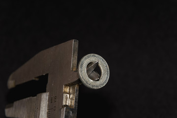 caliper measures the washer on a black background