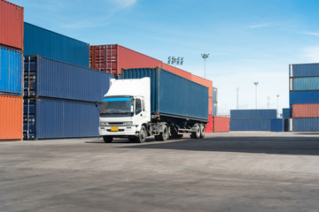 truck with cargo container on road in shipping yard