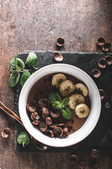 Chocolate pudding, banana and herbs in