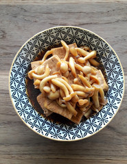 Steamed tofu and shimeji mushroom in soy sauce in a bowl