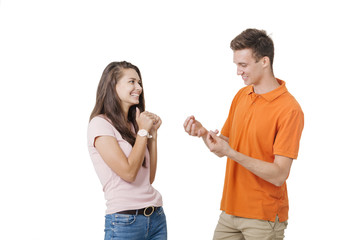 Happy lovely couple smiling and talking to each other about something. Studio shot over white background