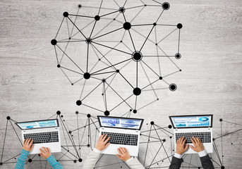 Top view of businesspeople sitting at table and using gadgets