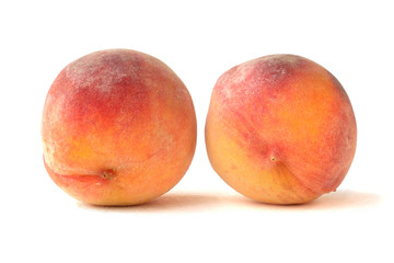 Pair of fresh peaches on white background for design