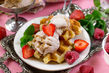 Belgian Liege waffles with strawberry ice cream and fresh berries