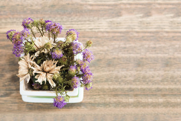 Purple flower on wood table.Copy space.