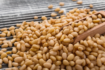 peeled pine nuts on a rustic background