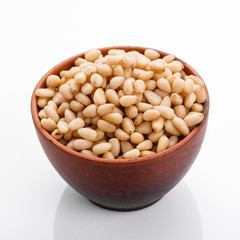 peeled pine nuts on a white acrylic background