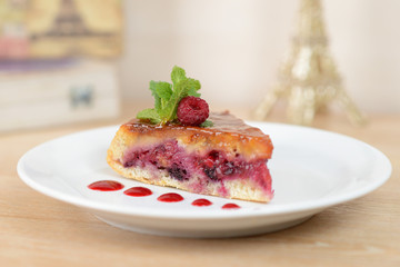 cake with raspberries on a white plate