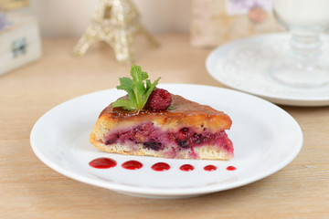 cake with raspberries on a white plate