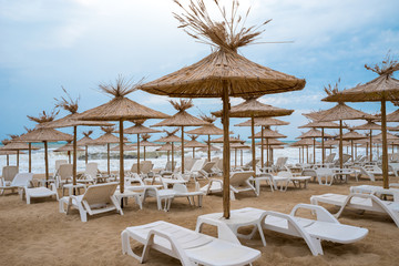 Beach Umbrellas with sun loungers on beach