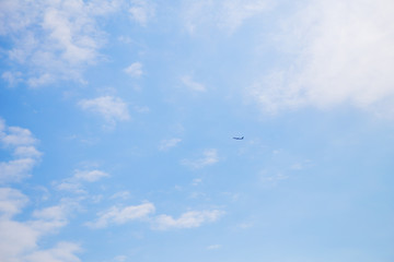 The plane flies away in a beautiful blue sky.