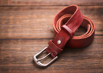 Strap of soft leather on a wooden background