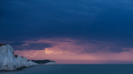 Stunning moody electrical lightning storm over white cliffs landscape, on English South Coast