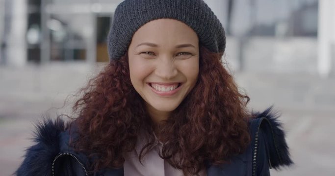 portrait cute young mixed race woman laughing enjoying successful urban lifestyle happy female student excited on college campus in city slow motion