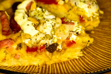 homemade pizza with peppers, plums, ham, sausage, cheese and spices, closeup
