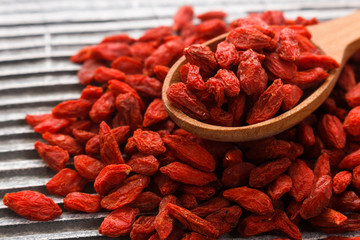 dried goji berries on a wooden rustic background