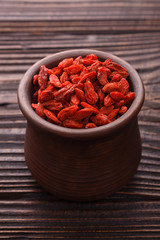 dried goji berries on a wooden rustic background