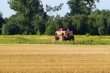 monster truck car rides through the meadow © Andrzej Płotnikow