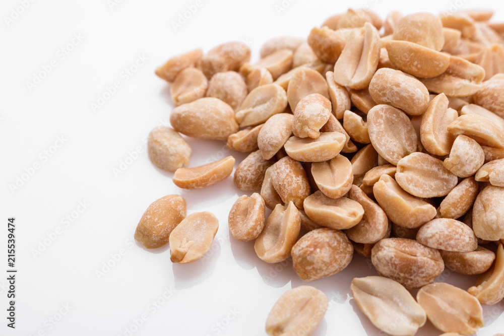 Wall mural fresh peanuts on a white acrylic background