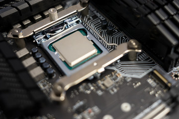 Computer mainboard in black with CPU but without CPU cooler
