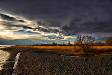 Mountains, clouds, sand and lake