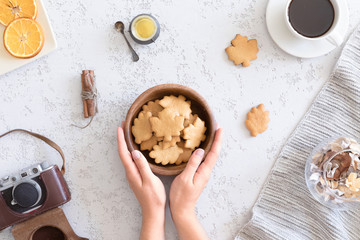 Flat lay of cozy autumn breakfast with homemade honey cookies and cup of tea, top view