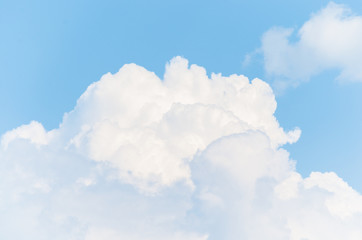 White cumulonimbus clouds on blue sky background.