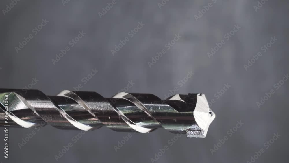 Aufkleber Silver drill bit rotation on a dark background. Macro view.