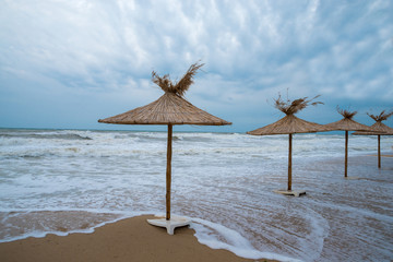 Straw umbrellas on a beautiful beach.