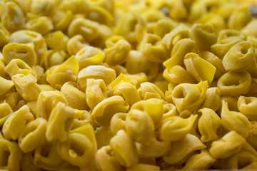 Fresh and uncooked tortellini, a traditional pasta from Bologna and Modena, Italy