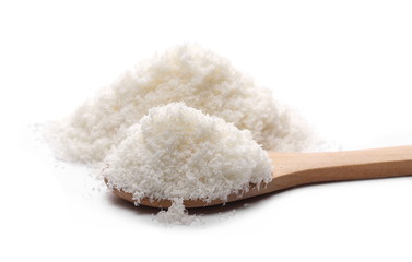 Pile of shredded coconut meat with wooden spoon isolated on white background