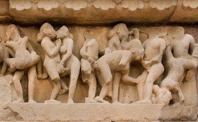 People in love scene in stone relief of ancient India. Khajuraho temple with sexual motif artworks,...