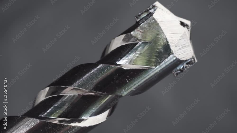 Aufkleber Silver drill bit rotation on a dark background. Macro view.